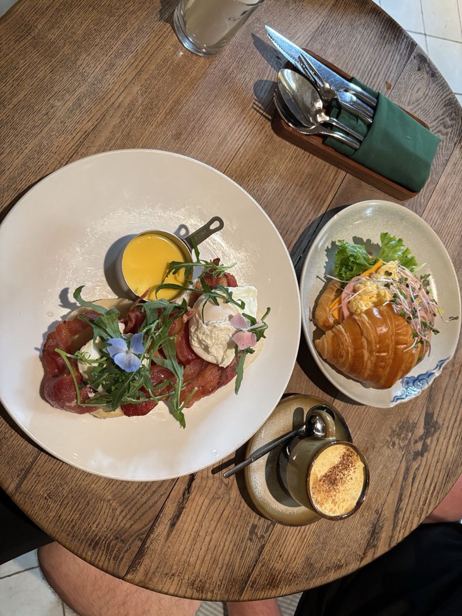 Our table from above: eggs Benedict, croissant and egg coffee