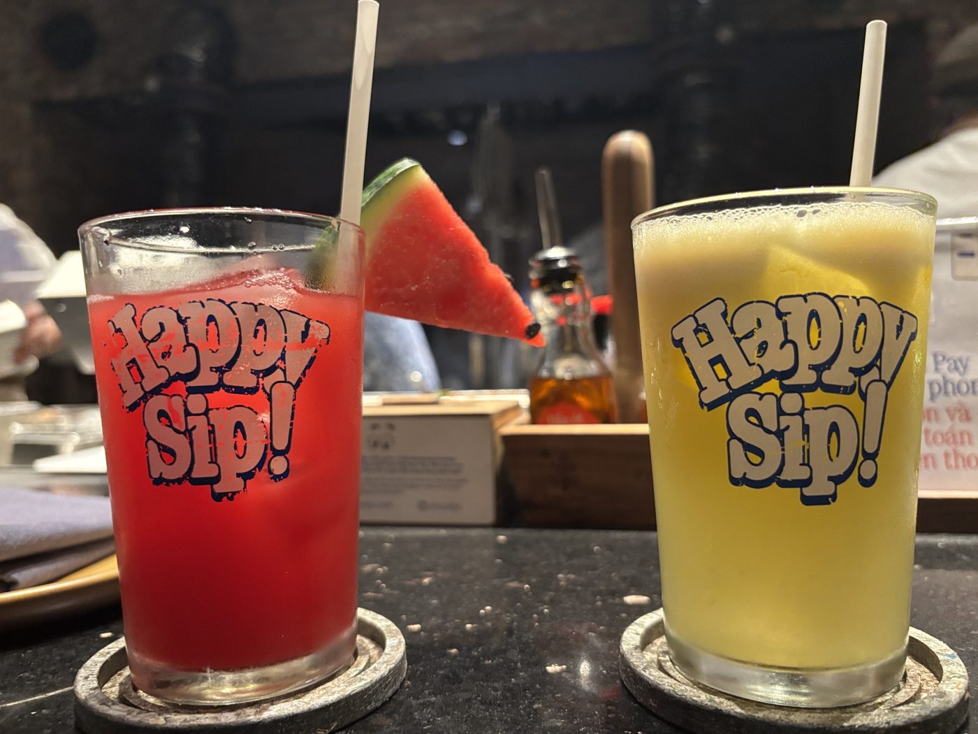 Two juices in Happy Sip glasses: watermelon and a yellow one
