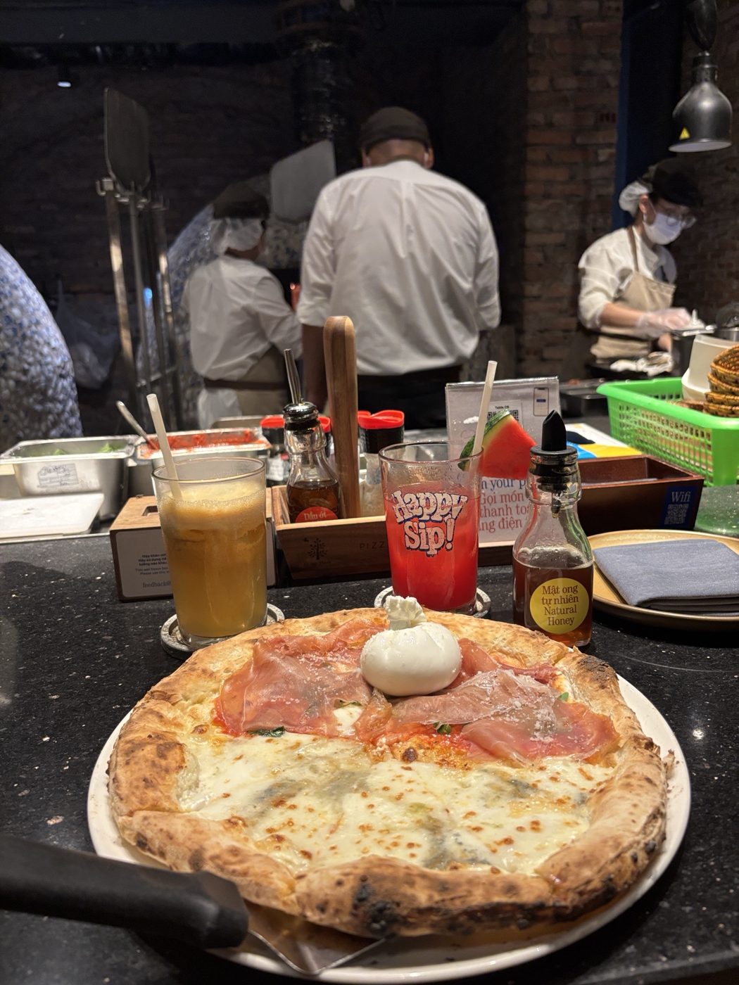 Half-and-half pizza: prosciutto with burrata, and cheese, in front of the oven